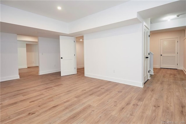 basement with light hardwood / wood-style floors