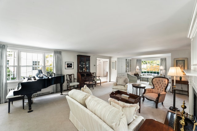 carpeted living room featuring ornamental molding and baseboard heating