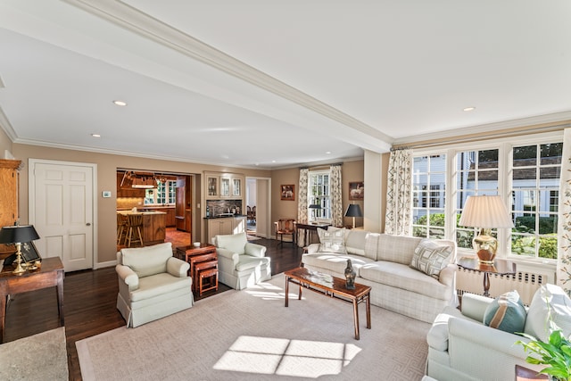 living room with ornamental molding, indoor bar, and hardwood / wood-style floors