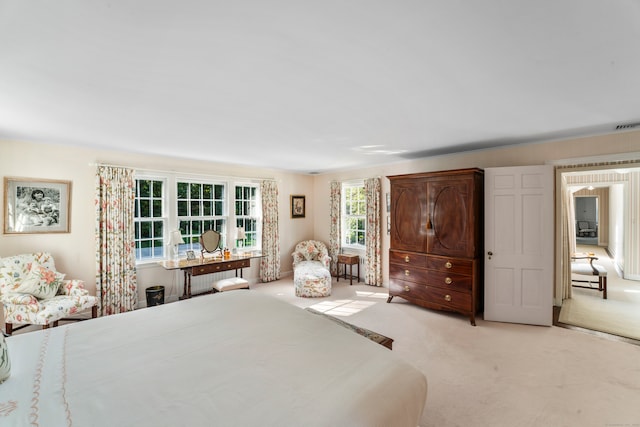 bedroom featuring light colored carpet