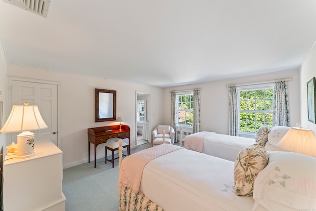 bedroom featuring crown molding and carpet