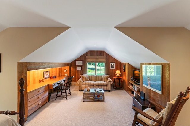 interior space featuring lofted ceiling, wood walls, and light colored carpet