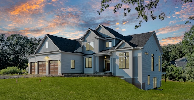 view of front of home with a lawn and a garage