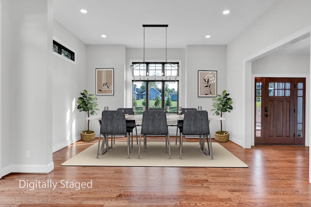 dining room with a notable chandelier and hardwood / wood-style flooring