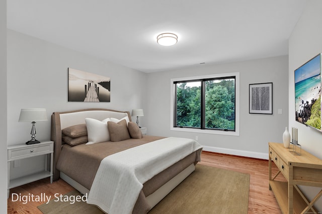 bedroom with hardwood / wood-style flooring