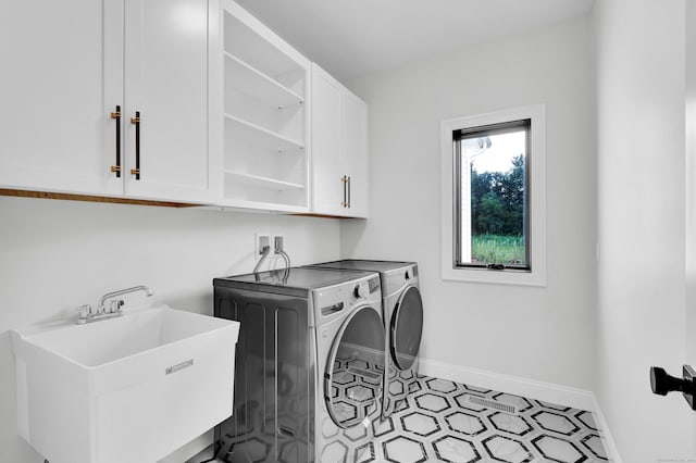 washroom featuring independent washer and dryer, cabinets, and sink