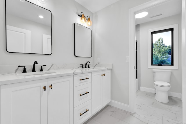 bathroom with double vanity, toilet, and tile patterned flooring