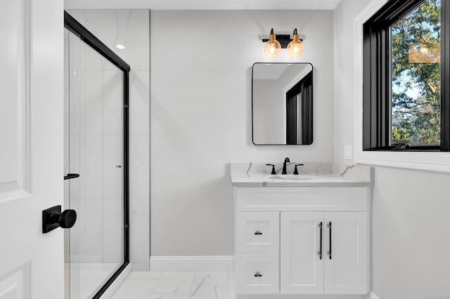 bathroom with vanity, plenty of natural light, and walk in shower