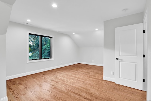 bonus room featuring lofted ceiling and light wood-type flooring