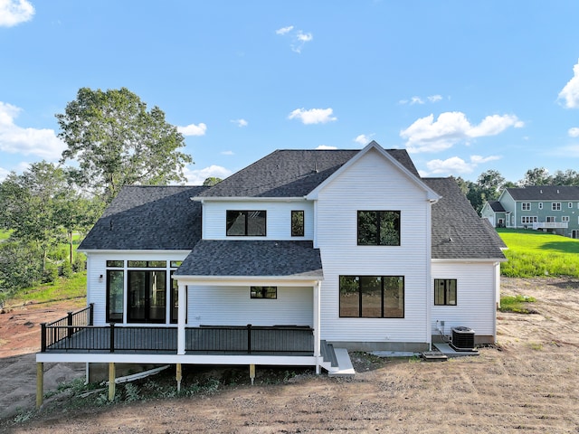 rear view of property featuring a wooden deck, central air condition unit, and a sunroom