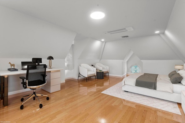 bedroom with lofted ceiling and light wood-type flooring