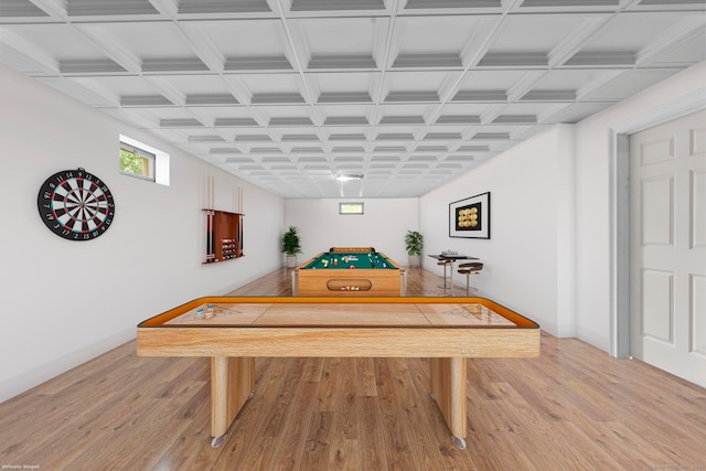 game room with light hardwood / wood-style floors and coffered ceiling