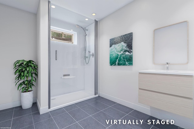 bathroom with vanity, tile patterned floors, and tiled shower