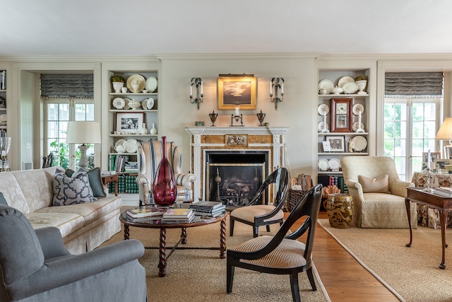 living room featuring built in shelves and hardwood / wood-style flooring