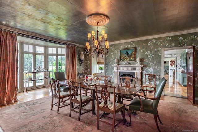 dining area with crown molding, an inviting chandelier, and hardwood / wood-style flooring