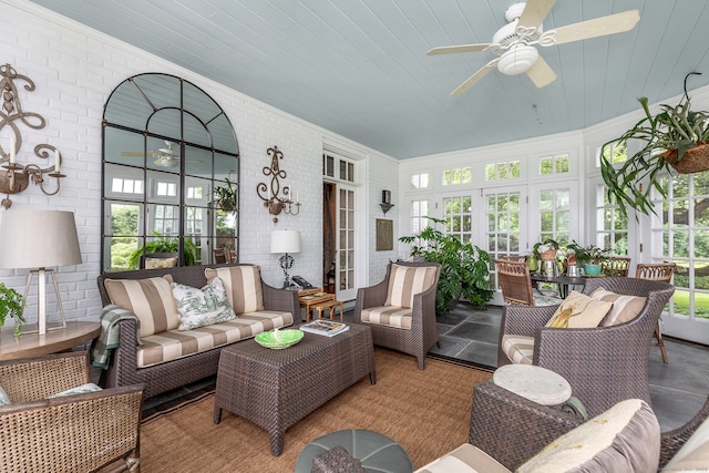 sunroom with wooden ceiling and ceiling fan