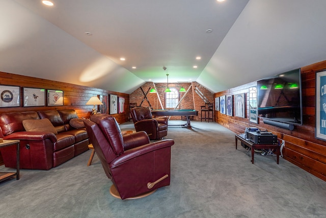 carpeted living room with pool table, wooden walls, and vaulted ceiling