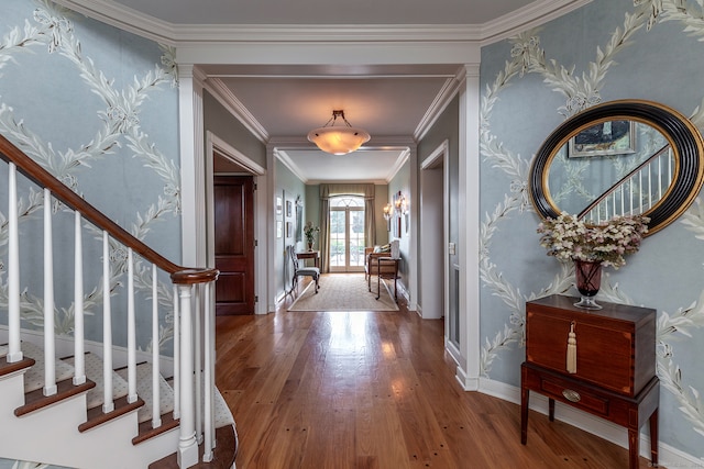 foyer featuring ornamental molding and hardwood / wood-style flooring