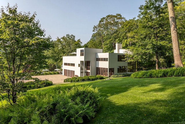23 Mauwee Brook Way, Kent, CT 06757 - view of front of house featuring a front lawn, stucco siding, and a chimney