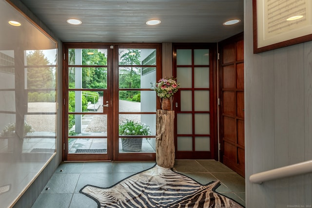 doorway with light tile patterned floors