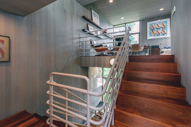 staircase with wood walls