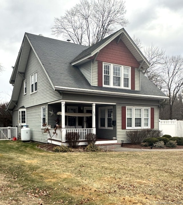 view of front of home with a porch and a front lawn