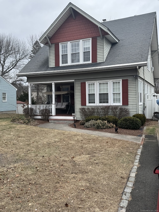 view of front of house featuring a front lawn and covered porch