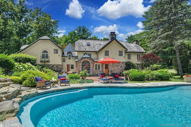 view of pool featuring a patio