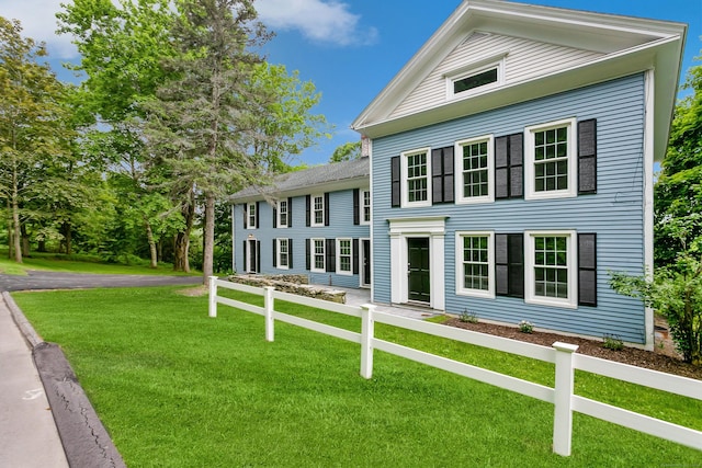 neoclassical home with a front yard