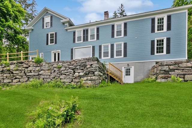 rear view of property with a yard