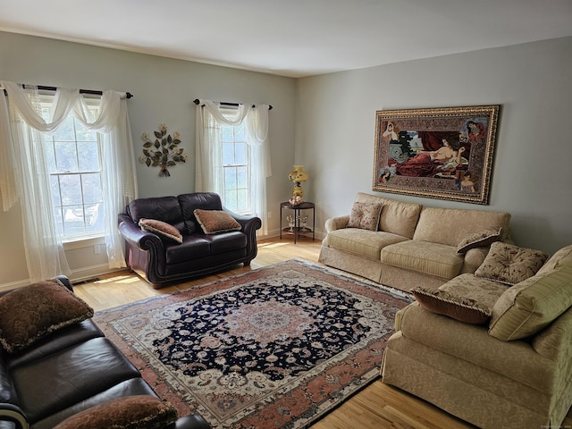 living room featuring a wealth of natural light and light wood-type flooring