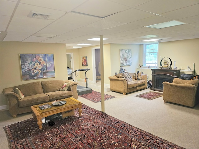 living room featuring carpet flooring and a paneled ceiling