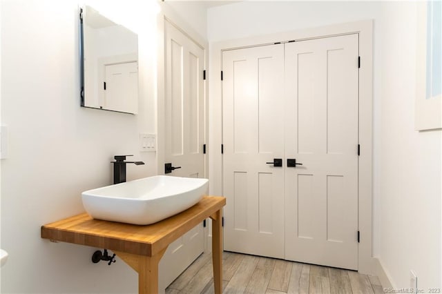 bathroom with sink and hardwood / wood-style flooring