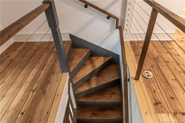 staircase with wood-type flooring