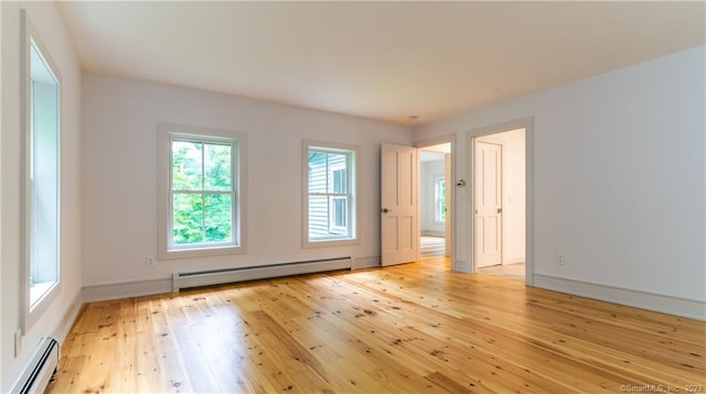 interior space with light hardwood / wood-style floors and baseboard heating