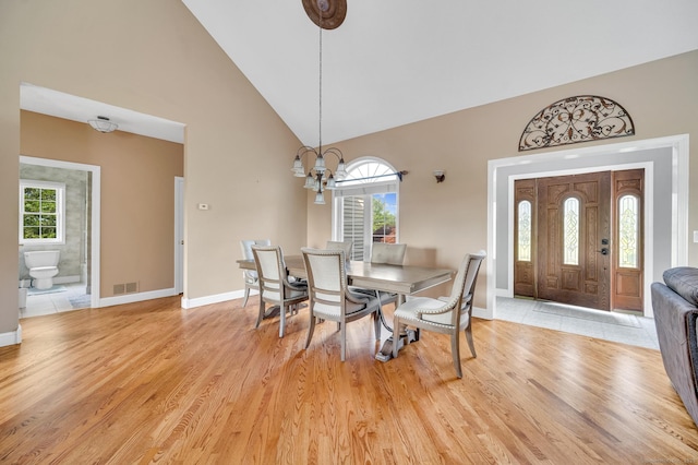 15 Huntington Ridge Rd, Wallingford, CT 06492 - dining room featuring high vaulted ceiling, baseboards, light wood-style flooring, and a chandelier
