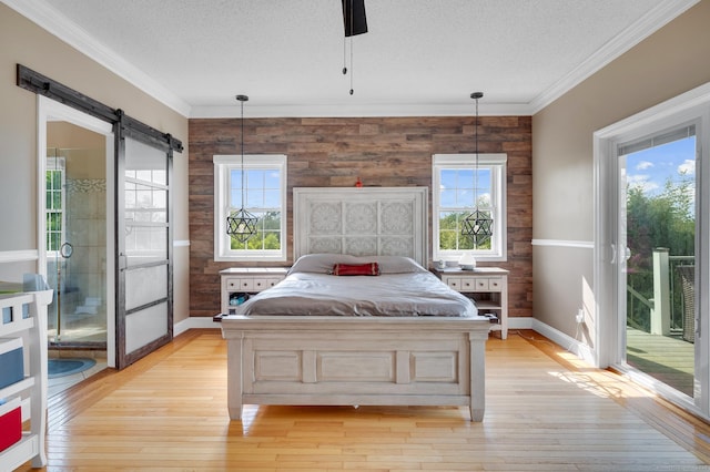 15 Huntington Ridge Rd, Wallingford, CT 06492 - bedroom featuring access to outside, a textured ceiling, a barn door, baseboards, and crown molding