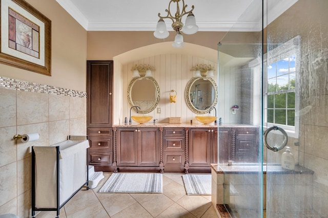 15 Huntington Ridge Rd, Wallingford, CT 06492 - bathroom featuring a chandelier, double vanity, tile patterned floors, crown molding, and tile walls