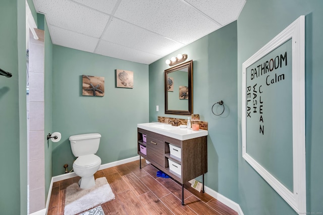 15 Huntington Ridge Rd, Wallingford, CT 06492 - bathroom with vanity, toilet, a drop ceiling, wood finished floors, and baseboards