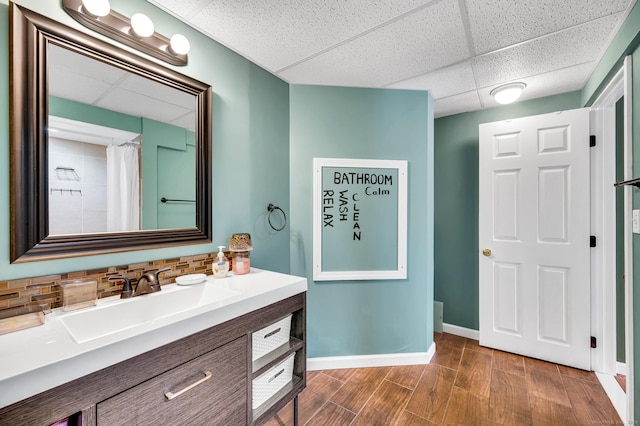 15 Huntington Ridge Rd, Wallingford, CT 06492 - full bathroom featuring a drop ceiling, decorative backsplash, vanity, wood finished floors, and baseboards