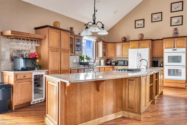 15 Huntington Ridge Rd, Wallingford, CT 06492 - kitchen featuring beverage cooler, white appliances, light stone counters, light wood-style flooring, and tasteful backsplash