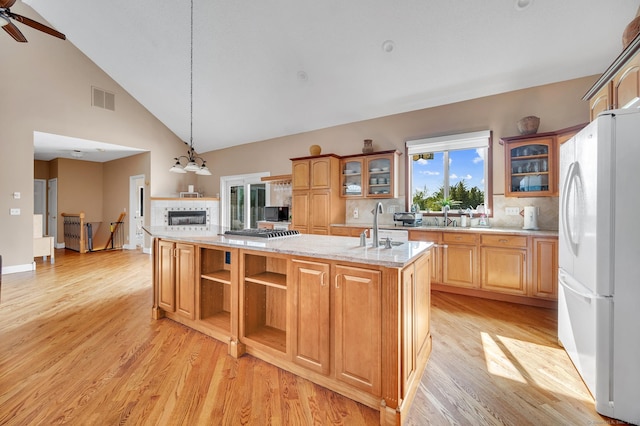 15 Huntington Ridge Rd, Wallingford, CT 06492 - kitchen featuring freestanding refrigerator, a center island with sink, open shelves, light wood-type flooring, and high vaulted ceiling