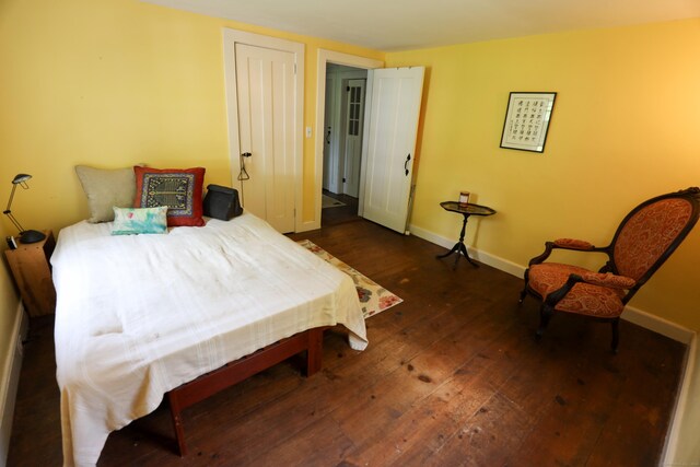 bedroom featuring dark hardwood / wood-style floors and a closet