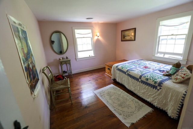 bedroom with dark wood-type flooring