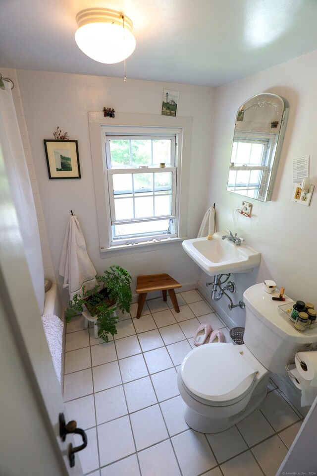 bathroom with tile patterned flooring, toilet, and sink