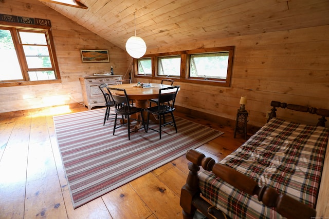 dining space with hardwood / wood-style floors, wood ceiling, and vaulted ceiling