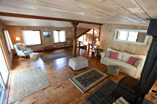 living room featuring a wealth of natural light, hardwood / wood-style floors, and wood walls