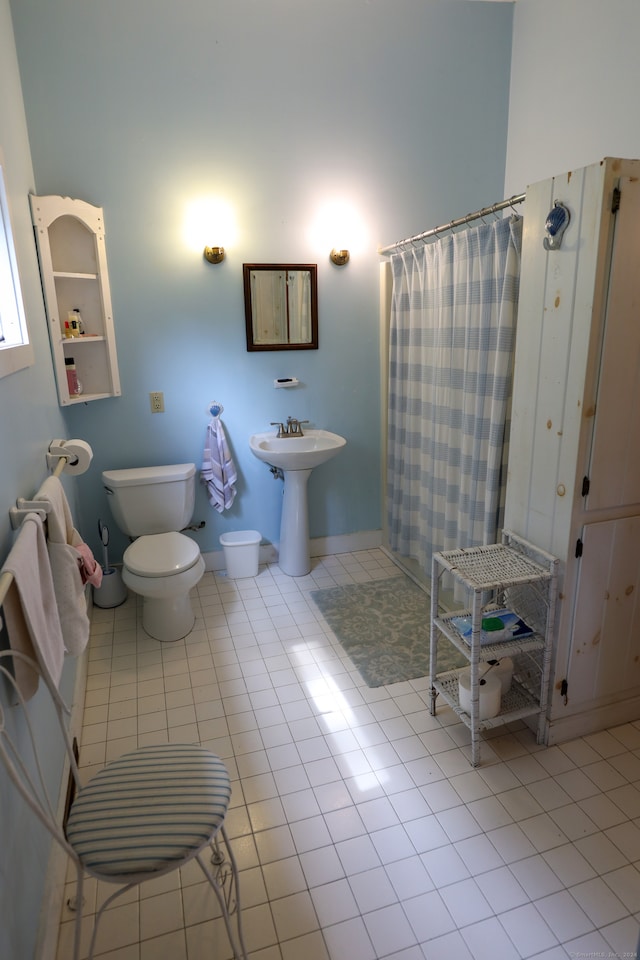 bathroom with toilet and tile patterned flooring