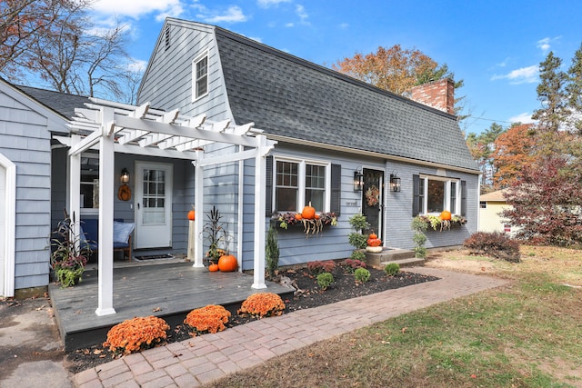 view of front of home with a wooden deck and a pergola