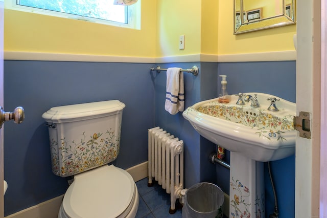 bathroom featuring tile patterned flooring, toilet, and radiator heating unit